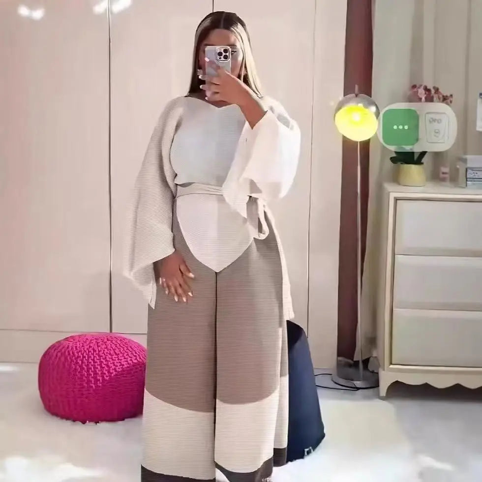 Conjunto de dos piezas de moda femenina para primavera, top suelto plisado irregular con retazos y cinturón, y pantalones de pierna ancha Miyake 2024