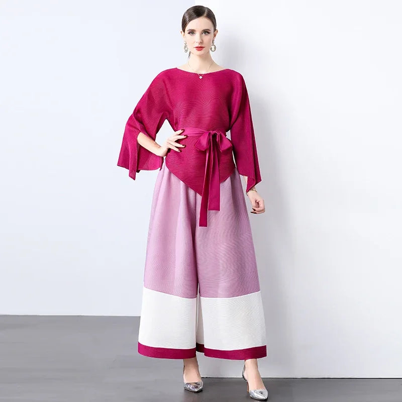 Conjunto de dos piezas de moda femenina para primavera, top suelto plisado irregular con retazos y cinturón, y pantalones de pierna ancha Miyake 2024