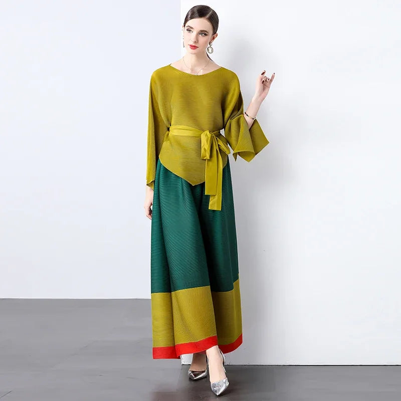 Conjunto de dos piezas de moda femenina para primavera, top suelto plisado irregular con retazos y cinturón, y pantalones de pierna ancha Miyake 2024