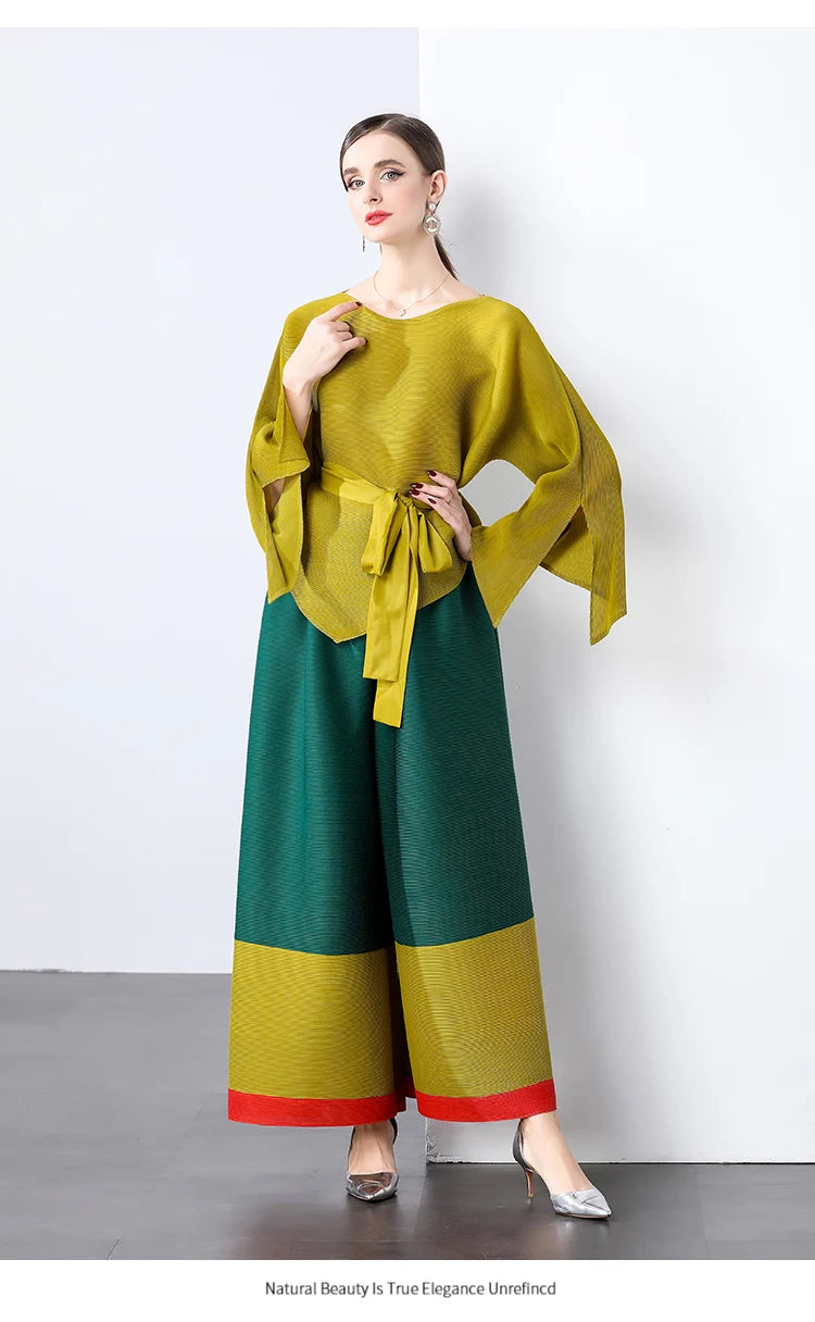 Conjunto de dos piezas de moda femenina para primavera, top suelto plisado irregular con retazos y cinturón, y pantalones de pierna ancha Miyake 2024